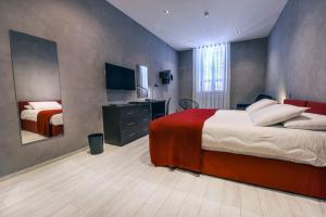 a bedroom with two beds and a sink and a mirror at Quaint Boutique Hotel Xewkija in Xewkija