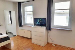 A television and/or entertainment centre at Cozy 1 room apartment in Magdeburg