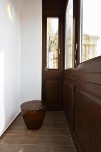 a wooden door with a basket in front of it at Quaint Boutique Hotel Xewkija in Xewkija