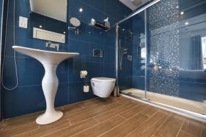 a bathroom with a sink and a toilet at Quaint Boutique Hotel Xewkija in Xewkija