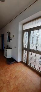 een lege kamer met twee ramen en een spiegel bij A casa di Emma in Nereto