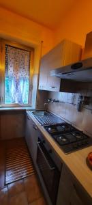 a kitchen with a stove top oven next to a window at A casa di Emma in Nereto