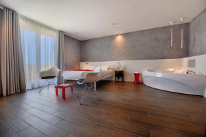 a room with a bed and a bathtub and a bedroom at Quaint Boutique Hotel Xewkija in Xewkija