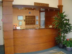 una zona de recepción de un hospital con puerta de madera en Morfeas Hotel, en Chalkida