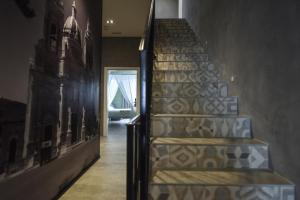 a staircase in a house with a painting on the wall at Quaint Boutique Hotel Xewkija in Xewkija
