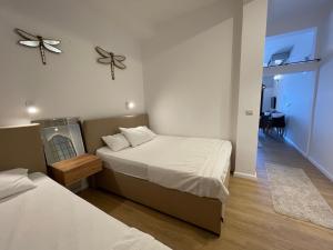 a bedroom with two beds and a ceiling fan at Apartments Lungo Mare in Sveti Stefan