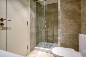 a bathroom with a shower and a toilet at Luxury Fontana Apartments in Budva