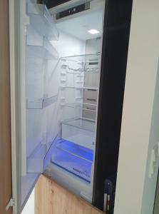 an empty refrigerator with its door open with its shelves at ORLIK in Gdynia
