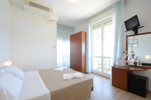 Postel nebo postele na pokoji v ubytování Hotel Caravel