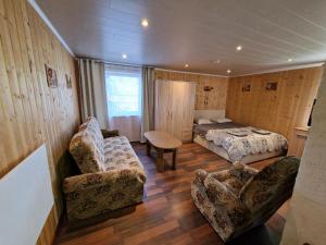 a bedroom with a bed and a couch and a table at Paju Majutus! in Ohtja