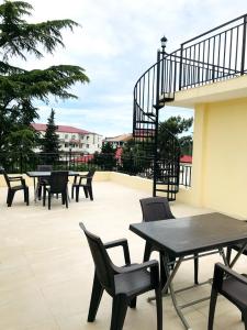 a group of tables and chairs on a patio at Gurya in K'obulet'i