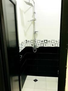 a black and white bathroom with a shower at Gurya in K'obulet'i