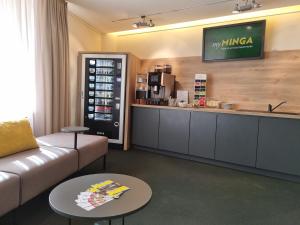 a living room with a couch and a coffee shop at myMINGA4 - Hotel & serviced Apartments in Munich +16 photos