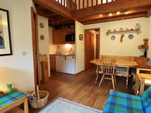 a kitchen and dining room with a table and chairs at Duplex cosy et spacieux avec piscine et balcon proche des pistes pour 4-5 personnes à Arêches-Beaufort - FR-1-342-171 in Arêches