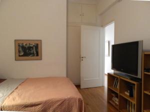 A television and/or entertainment centre at Elegant 3BD apartment in Kolonaki