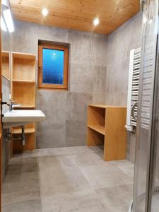 a bathroom with a sink and a window at Landhaus Brixental in Westendorf