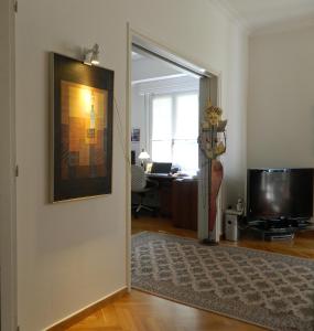 A television and/or entertainment centre at Elegant 3BD apartment in Kolonaki