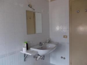 a white bathroom with a sink and a mirror at Big Brother Bed & Rooms in Treviso