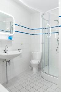 ein Bad mit einer Dusche, einem WC und einem Waschbecken in der Unterkunft Residence Juliana 14 Julianadorp aan zee in Julianadorp