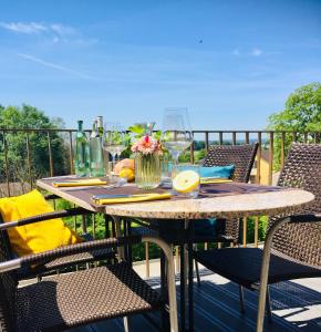 a wooden table and chairs on a balcony with a table and chairs at Hotel Rheingold in Gailingen