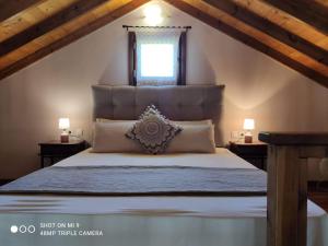 a bedroom with a large bed in a attic at Elia house 1 astoning sea view among the olive trees in Patitiri