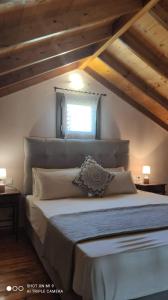 a bedroom with a large bed with a window at Elia house 1 astoning sea view among the olive trees in Patitiri
