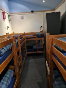 a room with three bunk beds in a room at Belford Hostel in Edinburgh
