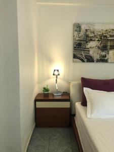 A bed or beds in a room at Plaisir Rooms