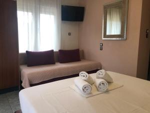 A bed or beds in a room at Plaisir Rooms
