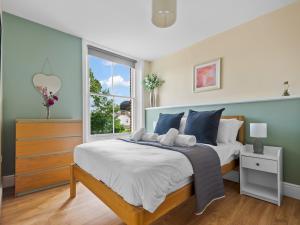 a bedroom with a large bed and a window at Pass the Keys Perfect 1-bed base in Canterbury with Parking in Canterbury