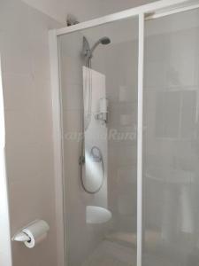 a shower with a glass door in a bathroom at Casa del Maestro in Olmeda de las Fuentes