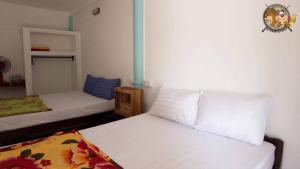 a bedroom with two beds with white sheets at Kep Melting Potes in Kep