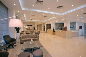 a lobby of a hospital with chairs and a waiting room at Nestor Hotel in Ayia Napa +37 photos