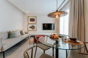 a living room with a table and a couch at Dock 1 Suites in Santa Cruz de Tenerife