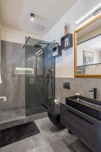 a bathroom with a shower and a toilet and a sink at Riva - the heart of palace in Split