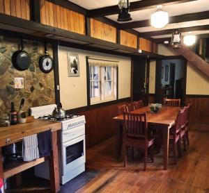 a kitchen and dining room with a table and a stove at Walhalla Guesthouses in Walhalla