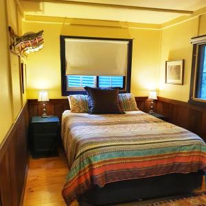 Un pat sau paturi într-o cameră la Walhalla Guesthouses