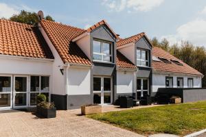 a row of houses with orange roofs at Sure Hotel by Best Western Limoges Sud in Feytiat