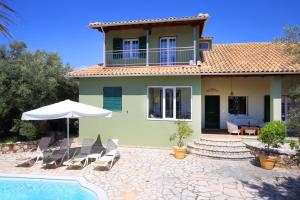 a villa with a swimming pool and a house at Elite Escape in Tsoukalades
