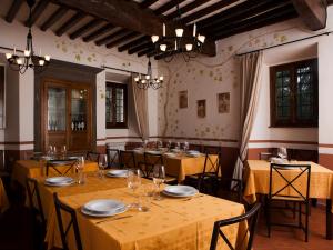 a dining room table with chairs and a table cloth at Agriturismo La Topaia in Borgo San Lorenzo