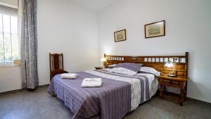 A bed or beds in a room at Huerta del Chacho Ronda by Ruralidays