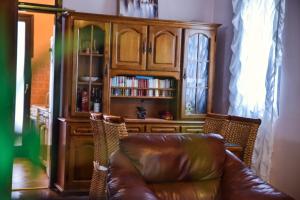 a living room with a leather couch and a book shelf at Apartment Monika in Ulcinj