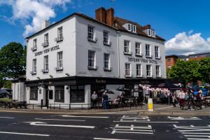 a white building on the corner of a street at Severn View Hotel in Worcester