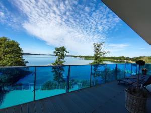 a view from the deck of a house overlooking the water at Apartament 309 in Boszkowo