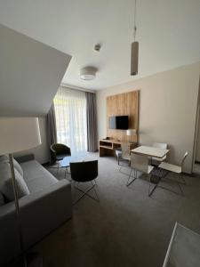 un soggiorno con divano e tavolo di Aparthotel Apartamenty Czarna Góra 340 a Sienna