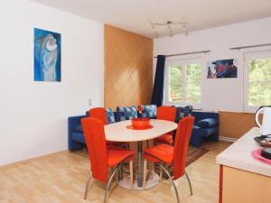 a kitchen and dining room with a table and chairs at Holiday Apartment Nana in Reichenfels