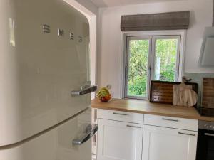 a kitchen with white cabinets and a window at Ferienhaus Leezen in Leezen