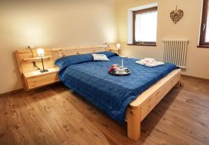 Postel nebo postele na pokoji v ubytování La Marmote Albergo Diffuso di Paluzza San Nicolò