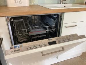 a dishwasher with its door open in a kitchen at Ferienhaus Leezen in Leezen