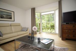 a living room with a couch and a coffee table at Ferienhaus Wiking Haus - Terrasse und Garten in Binz